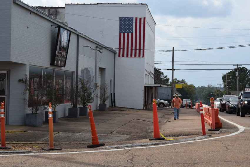 Workers put up barricades in preparation for closing part of Byrd Avenue that started at 5 p.m. Friday in order to accommodate work on the Ellis Theater.